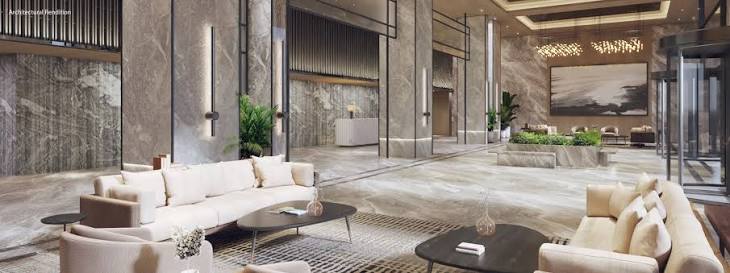 Modern marble lobby lounge with cream seating, stone columns, and glass entry doors